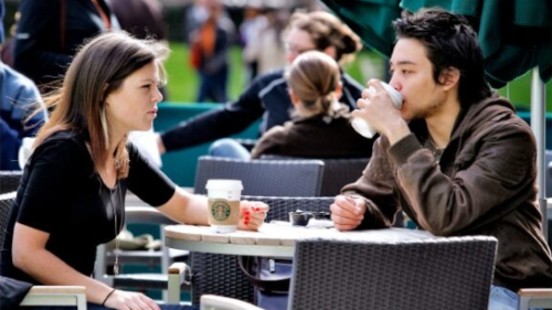 postgraduate taught masters students drinking coffee in sunshine outdoors in edinburgh