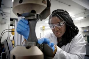 Wini Obande, PhD Student, working in the laboratory, wearing protective gear