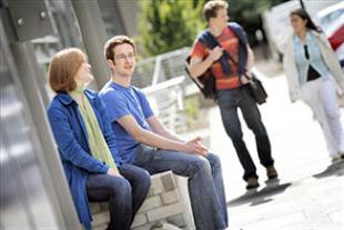 Engineering students sitting outside the AGB Building on King's Buildings Campus, in summer