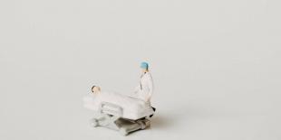 photograph of plastic figure doctor and patient in a white space