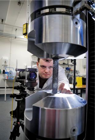 Researcher testing the strength of engineering materials