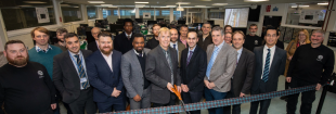 Doug Baney of Keysight Technologies cuts ribbon, surrounded by staff from the School of Engineering's Electronics and Electrical Engineering staff team