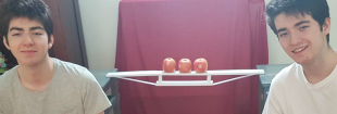  Summer school students Antoine and Alexandre Fromentel with their bridge (centre) constructed from minimal basic materials, in order to support the weight of an apple