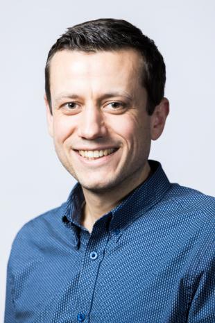 profile photo of Timm Krueger wearing blue shirt and smiling