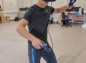 A student wearing a virtual reality VR headset in the Engineering Makerspace